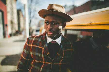 bokeh, cars, eyes, hat, jacket, lamppost, lips, male