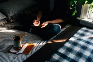 bed, comfort, mug, Notepad, pencil, pillow, plaid, window