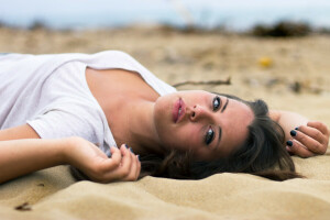 brunette, girl, lies, look, pose, sand