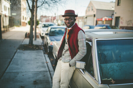 bokeh, branch, cars, city, eyes, hat, lamppost, male