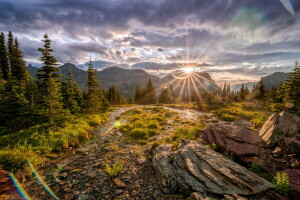 clouds, Glacier National Park, glare, mountains, Rays, rocks, stones, the sky